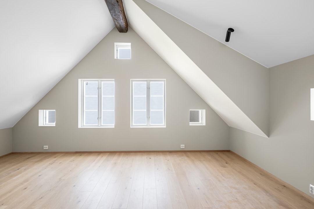 an-empty-room-with-a-vaulted-ceiling-and-windows-fkpxsy-wdxe
